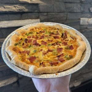 Quiche with bacon and vegetables in foil.